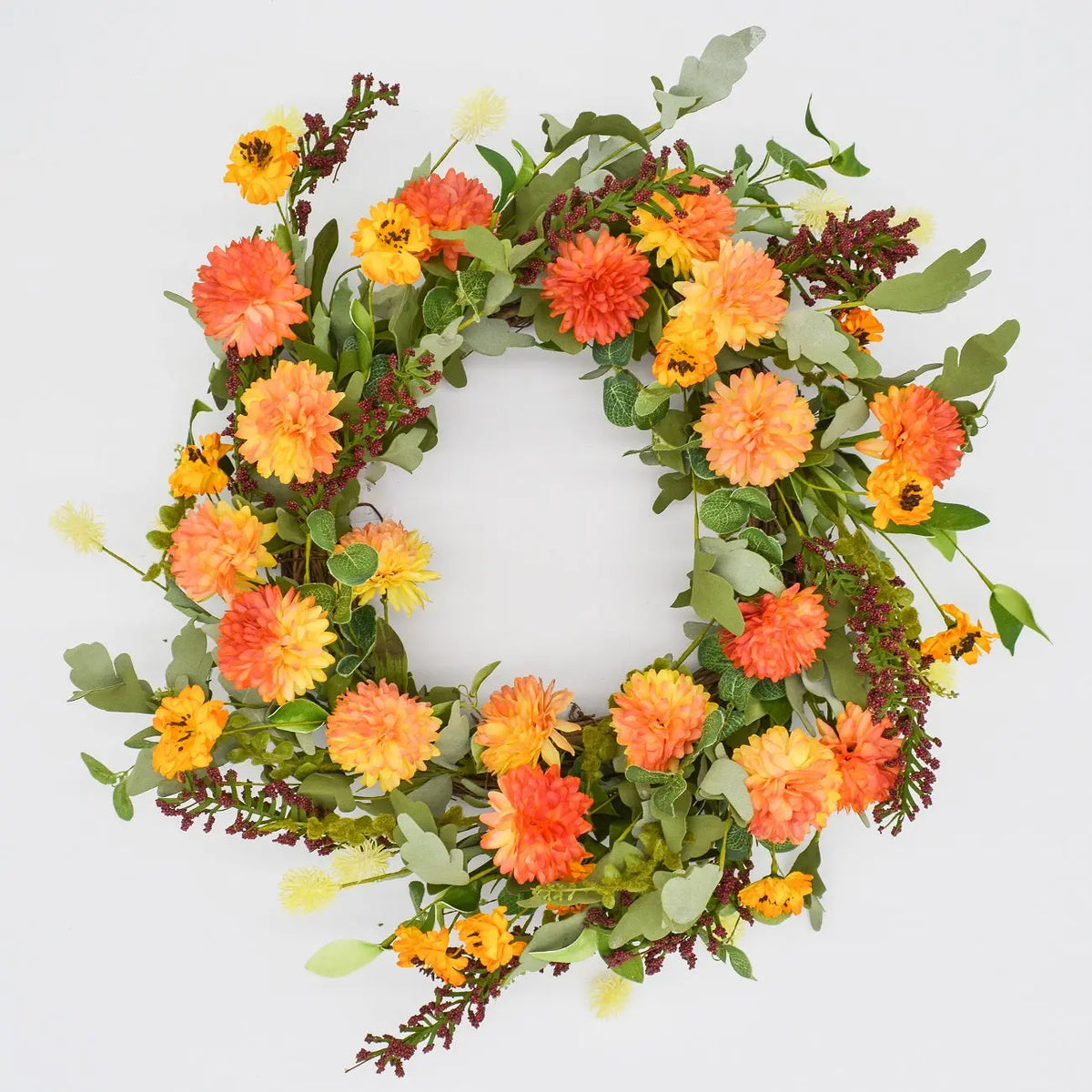 Fall wreath with orange and yellow flowers and autumn foliage